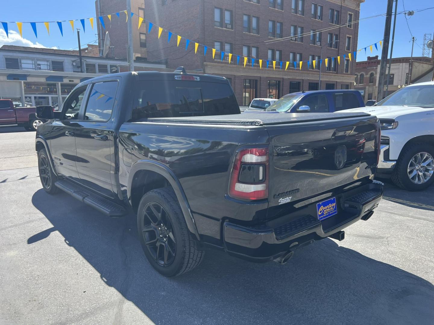 2021 Black /Black RAM 1500 Laramie Crew Cab SWB 4WD (1C6SRFJT8MN) with an 5.7L V8 OHV 16V engine, 8A transmission, located at 116 5th Avenue South, Lewistown, MT, 59457, 47.063877, -109.427879 - 2021 Ram 1500 Laramie Crew Cab 4WD, powered by a robust 5.7L HEMI engine. This truck combines luxury with rugged capability, offering premium leather seating, advanced technology features, and superior towing capacity. The spacious crew cab ensures comfort for all passengers, while the 4WD system gi - Photo#3